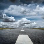 gray rolled asphalt road under cloudy sky